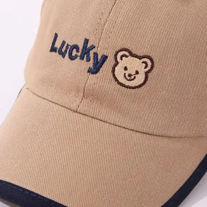 Kids baseball cap with khaki crown, navy brim and Lucky bear cartoon embroidery