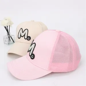 Detail of breathable mesh baseball caps with M embroidery and smiley in beige and pink