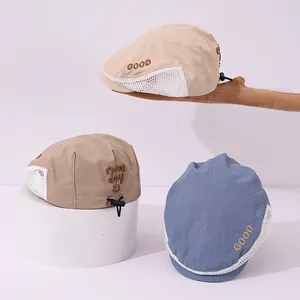 Detail of breathable mesh sides and adjustable drawstring on children's beret hats