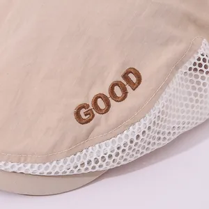 Close-up of mesh detail and GOOD embroidery on breathable kids' beige beret cap