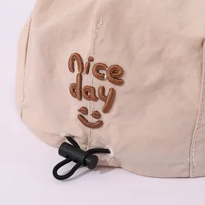 Breathable beige kids beret hat with Nice Day embroidery and adjustable drawstring cord