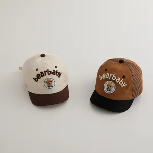 Close-up of baby mesh baseball hats with bear embroidery and breathable fabric