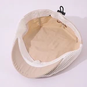 Detail of breathable mesh kid's beret featuring adjustable drawstring and embroidery