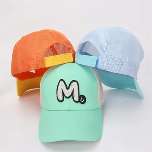 Close-up of breathable mesh baseball caps with M embroidery and smiley face patches