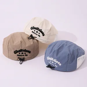 Detail of children's mesh berets featuring breathable side panels and adjustable elastic buckles