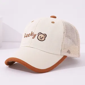 Detail of LUCKY bear embroidery and mesh paneling on a kids baseball cap