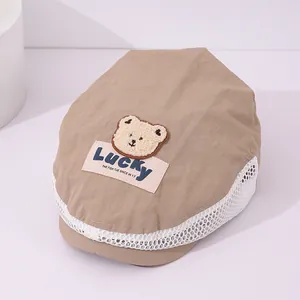 Detail of mesh side panel and 3D teddy bear patch on kid's breathable beret cap
