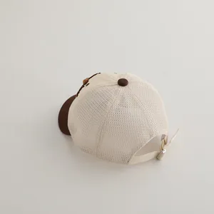 Detail view of baby mesh baseball cap with breathable brown net and adjustable metal buckle