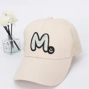 Detail of breathable mesh baseball cap with M letter patch and mini smile embroidery