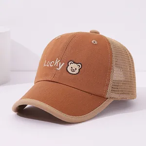 Detail of LUCKY bear embroidery and breathable mesh on children brown baseball cap