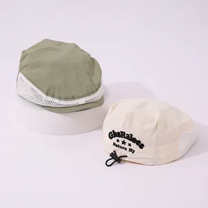 Detail of breathable mesh summer beret for kids with NICE DAY embroidery and toggle