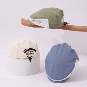 Close-up of kids beret hats with breathable mesh panels and adjustable elastic drawstrings