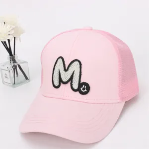 Detail of pink mesh baseball cap with white M letter embroidery and breathable back panel