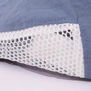 Macro shot of blue ripstop fabric and white honeycomb breathable mesh on kids cap