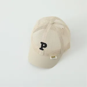 Detailed view of beige mesh baseball cap with black P embroidery and breathable design