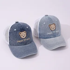 Close-up of denim mesh baby baseball caps with cute bear embroidery and mesh back