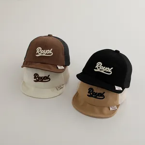 Detail of four breathable mesh trucker hats for kids featuring Royal 3D embroidery