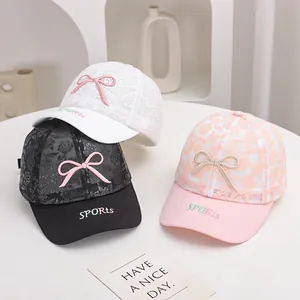 Close-up of lace mesh baseball caps featuring 3D bows and SPORTS embroidery in three colors