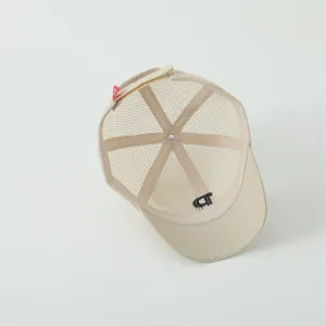 Internal view of beige kids baseball cap showing mesh fabric and embroidery details