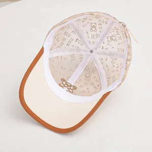 Detailed close-up of breathable mesh lining with cartoon bear patterns on children cap