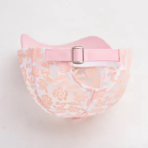 Detail of children's mesh baseball cap with pink adjustable strap and orange floral lace