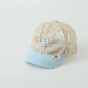 Detail of breathable mesh fabric and 'P' embroidery on kids' summer baseball cap