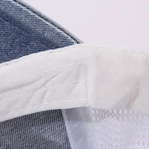 Detail shot of denim fabric with mesh lining and reinforced stitching on a kids hat
