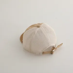 Detail of breathable mesh back and adjustable metal buckle on kids baseball cap