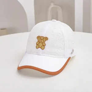 Detail of breathable mesh kids' baseball cap featuring embroidered bear patch and brown trim