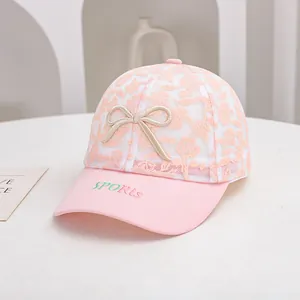 Detailed view of pink lace mesh sun hat with floral texture and decorative 3D bow accent