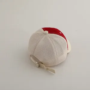 Detail of adjustable metal buckle and breathable mesh on red and beige kids baseball cap