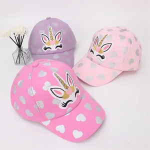 Detailed view of kids unicorn baseball caps with silver heart patterns in three colors