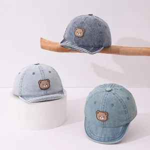 Detailed view of kids denim baseball caps in three wash tones with cute bear patches