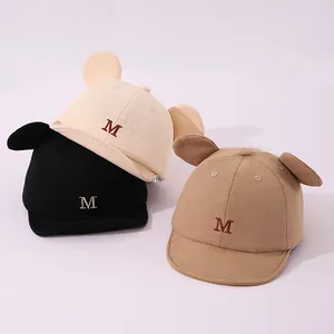 Detailed stack of kids' baseball caps with 3D animal ears and embroidered M logo