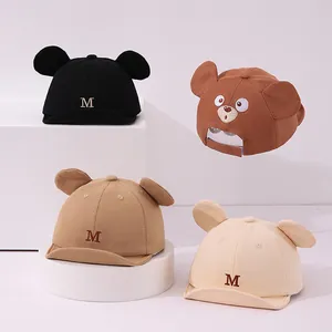Variety of baby baseball caps with soft brims and cute animal ear details in neutral tones