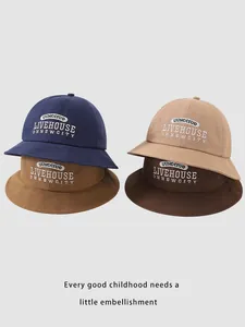 Detail of four colorful cotton sun hats for kids featuring premium white letter embroidery
