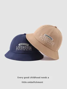 Close-up of cotton baby bucket hats in navy and khaki with detailed embroidery