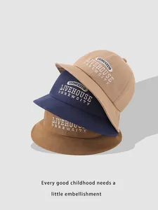Detail of embroidered cotton bucket hats for kids in khaki, navy blue, and brown tones