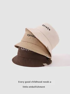 Detail of cotton bucket hats for toddlers with RANHSR letter embroidery and fabric label