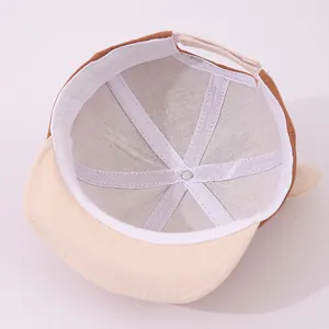 Détail de la structure interne et de la bande velcro réglable d'une casquette pour bébé