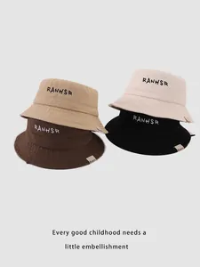 Close-up of embroidered canvas bucket hats in khaki, cream, brown, and black colors