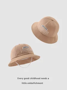 Detailed embroidery on khaki cotton bucket hat with white adjustable windproof chin strap