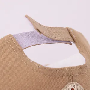 Detail of adjustable Velcro strap on the khaki cotton baseball cap for a custom fit