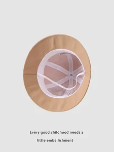 Detailed interior of khaki cotton kids sun hat showing breathable mesh lining and strap