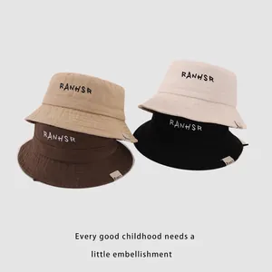 Kids cotton bucket hats with RANHSR letter embroidery in four solid neutral colors