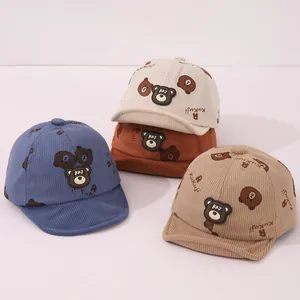 Détail de casquettes en velours côtelé pour bébé avec bord souple et écusson ours