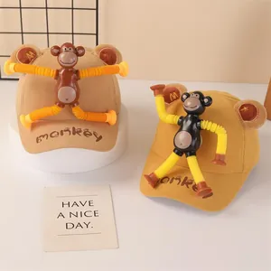 Kids corduroy baseball caps with cute monkey dolls in light brown and mustard yellow