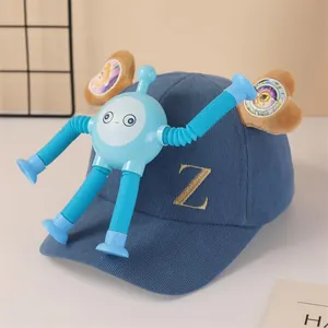Detail view of blue baseball cap with gold 'Z' embroidery and detachable blue robot toy