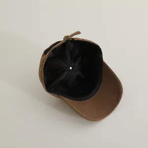 Detail view of brown corduroy toddler cap showing mesh lining and adjustable strap