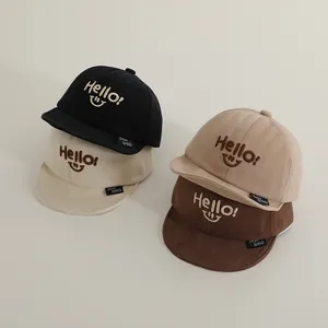Detailed view of kids cotton baseball caps in black, beige, khaki, and brown colors